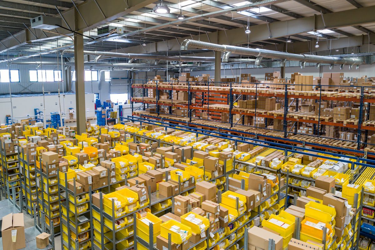 Various LCL cargo items being loaded into a shared shipping container in a warehouse
