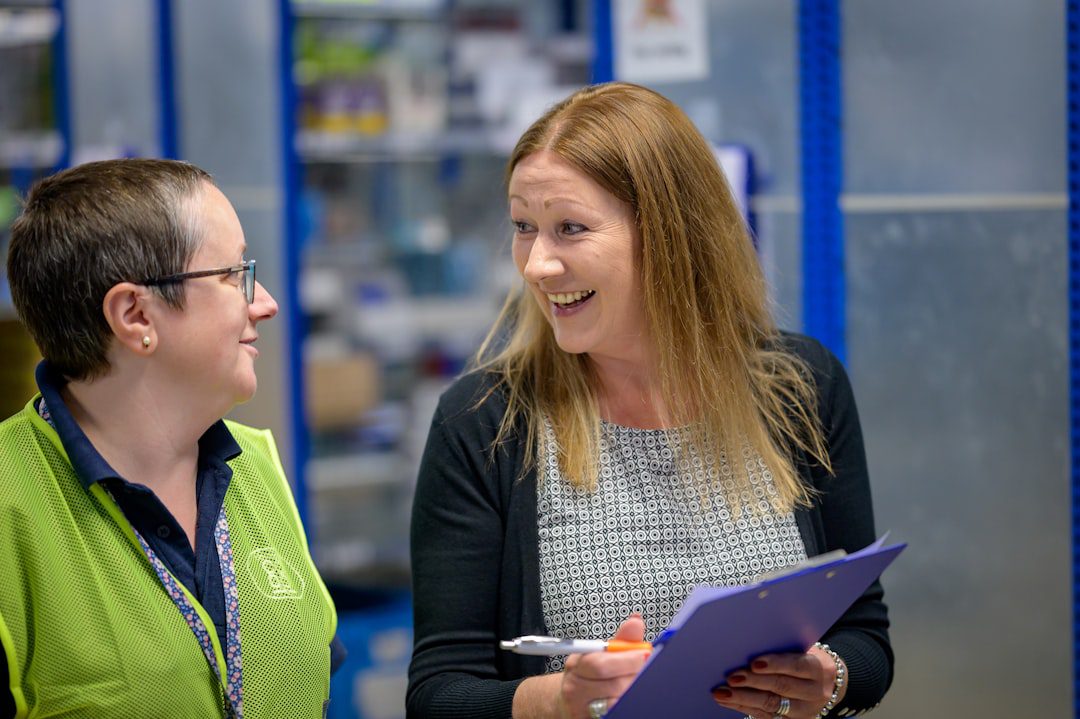 A freight forwarder and client discussing shipping costs and logistics in an office setting