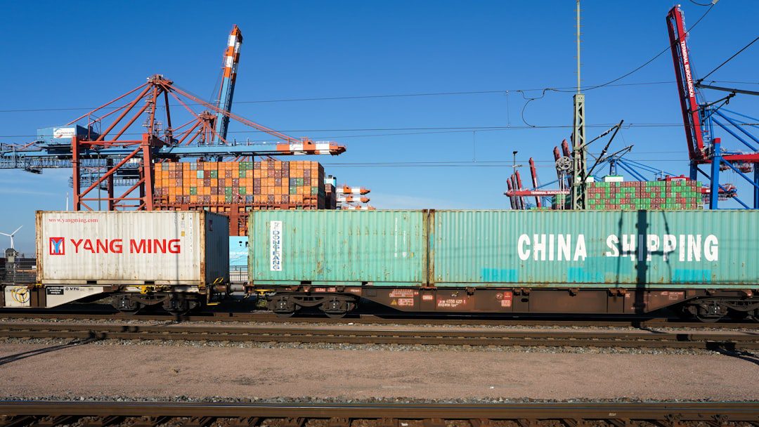 Shipping containers stacked high at a busy port in China, ready for export