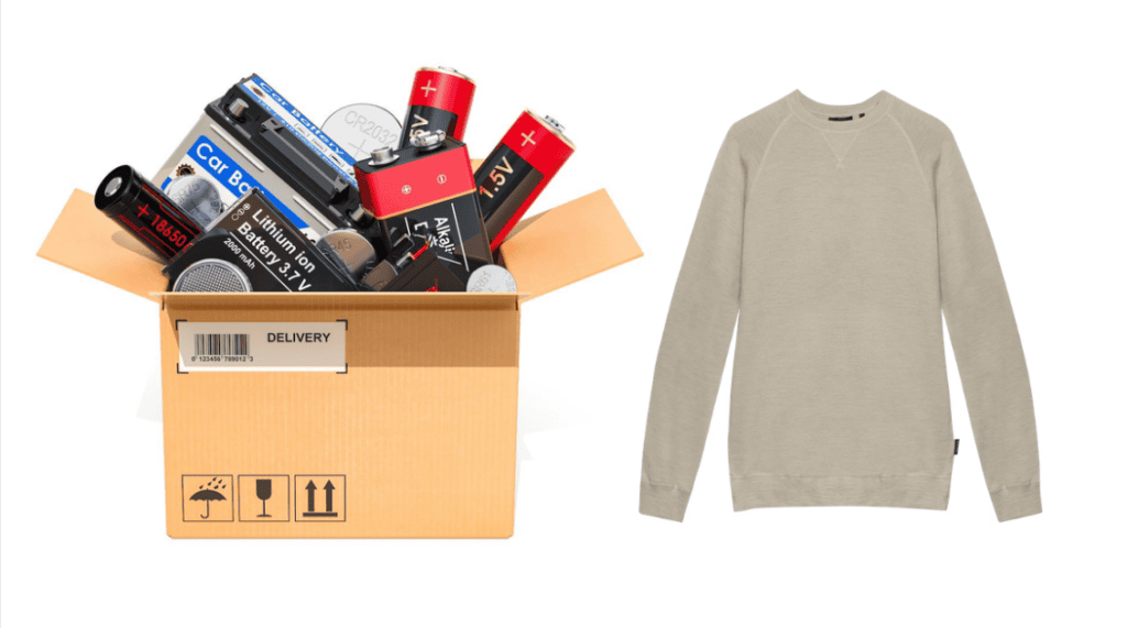 Open cardboard delivery box overflowing with assorted batteries (car battery, lithium-ion, alkaline, button cells) next to a plain beige crewneck sweatshirt