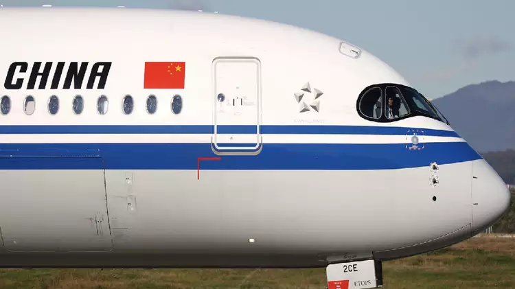 A close-up of a white airplane with "CHINA" text and the Chinese flag, representing affordable air freight forwarding services from China.